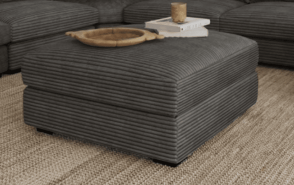 a plush upholstered ottoman in gray fabric with a hollow space for discreet storage in the family room office