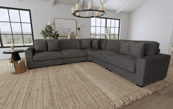 a gray upholstered modular sectional sofa reconfigured in a roomy setting for family time