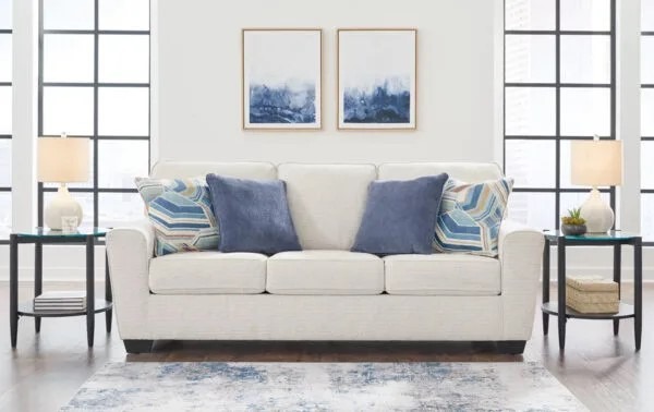 Light and airy spring home decor with light-colored sofas, bright accents, glass end tables, minimalist table lamps, and wall art