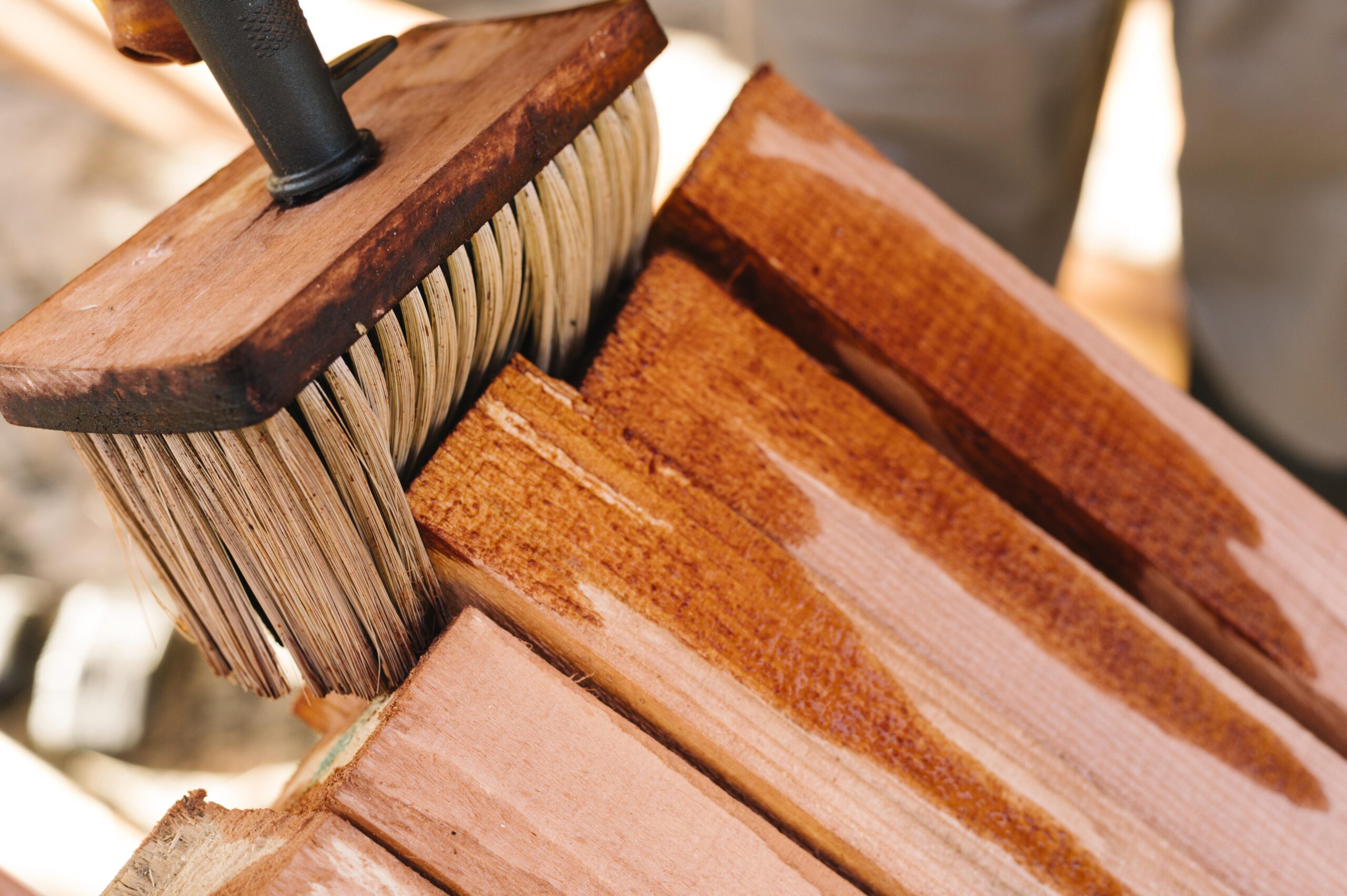 applying sealant on a wooden furniture frame as a part of spring furniture cleaning