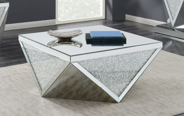 An abstract, geometric coffee table design with shiny mirrored surfaces for a bright and illuminating spring home decor