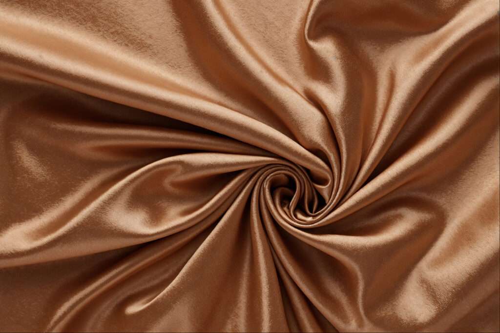 Close up of smooth and luxurious silk in light brown color
