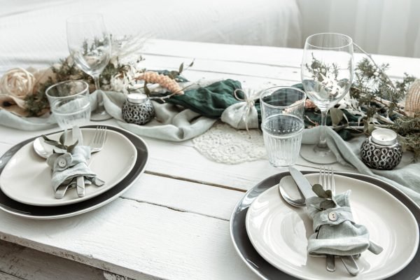 Festive table setting at home with Scandinavian decor details close up.